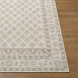 Close-up of the neutral Cicely Area Rug showing its traditional pattern and jute texture on wood floor. Front