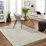 Light beige Posof Area Rug in a bright home office with white desk, gray chair, and wood floors. Roomscene-Rectangle