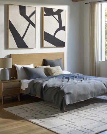 Modern bedroom with wood floors and ivory Yetty Area Rug featuring a geometric pattern. Roomscene-Rectangle