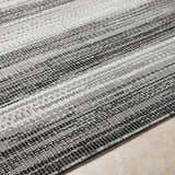 Close-up of Kris Black Area Rug showing woven texture and beachhouse and dark gray stripes. Texture