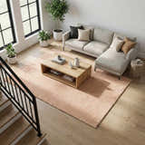 Living room with blush pink Kanuha Washable Area Rug, light wood floors, gray sofa, and modern coffee table. Roomscene-Rectangle
