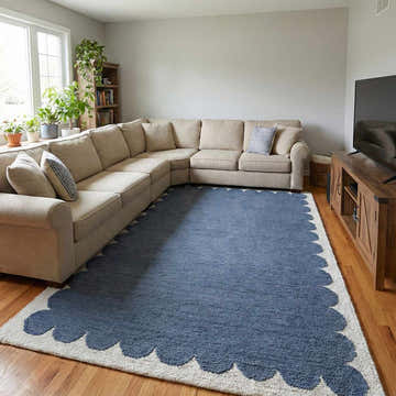 Living room with beige sectional and blue Lukamu Modern Art Deco rug with ivory scalloped edge on wood floor. Roomscene-Rectangle