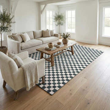 Living room scene with a Kaysar Oil Green Checkered Washable Area Rug, beige sofa, wood coffee table, and natural light. Roomscene-Rectangle