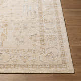 Close-up of the Zudea Beige Medallion Rug. Traditional style with beige, cream, and tan tones. Machine woven polyester. Corner