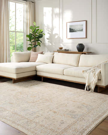 Living room with a beige sectional sofa and the Vintage Edit Rachel Zoe x LIVABLISS RZVE-2300 Area Rug. Roomscene-Rectangle