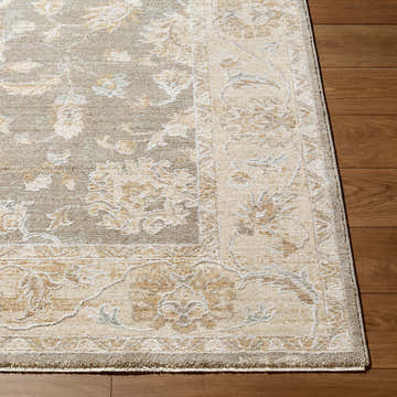 Close-up of the Jexae Gray Persian rug. Beige, cream, and gray floral pattern on a machine woven polyester rug. Corner