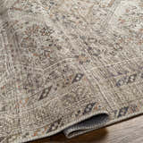 Close-up of the Barny Beige Flat Pile Washable Rug showing its traditional pattern, neutral colors, and flatweave texture. Fold