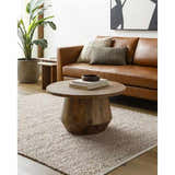 Living room scene with a Kamil Beige Solid Area Rug, leather sofa, and wood coffee table. Roomscene-Rectangle