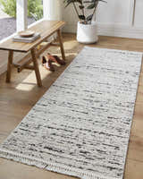 Hallway scene with Elian Area Rug in bone and gray, wood bench, and potted plant. Roomscene-Runner