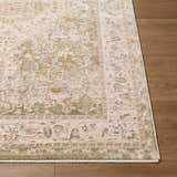 Close up of the Khayri Area Rug showing beige, cream, gray, olive and tan colors with a traditional pattern on wood floor. Front