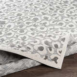 Close-up of Seascale Outdoor Carpet. Gray and white animal print, machine woven polypropylene rug. Contemporary style. Fold