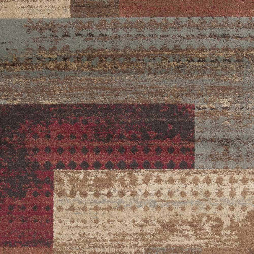 Close-up of the Sentinel Riley Geometric Rug. Features red, tan, brown, and gray hues in a modern geometric pattern. Swatch
