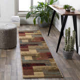 Home office scene with Sentinel Riley geometric runner rug, wood desk, potted plants, and gray knit ottoman. Roomscene-Runner