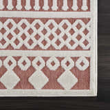 Close-up of the Jove Orange Outdoor Rug showing a bone and terracotta geometric Southwestern pattern. Swatch