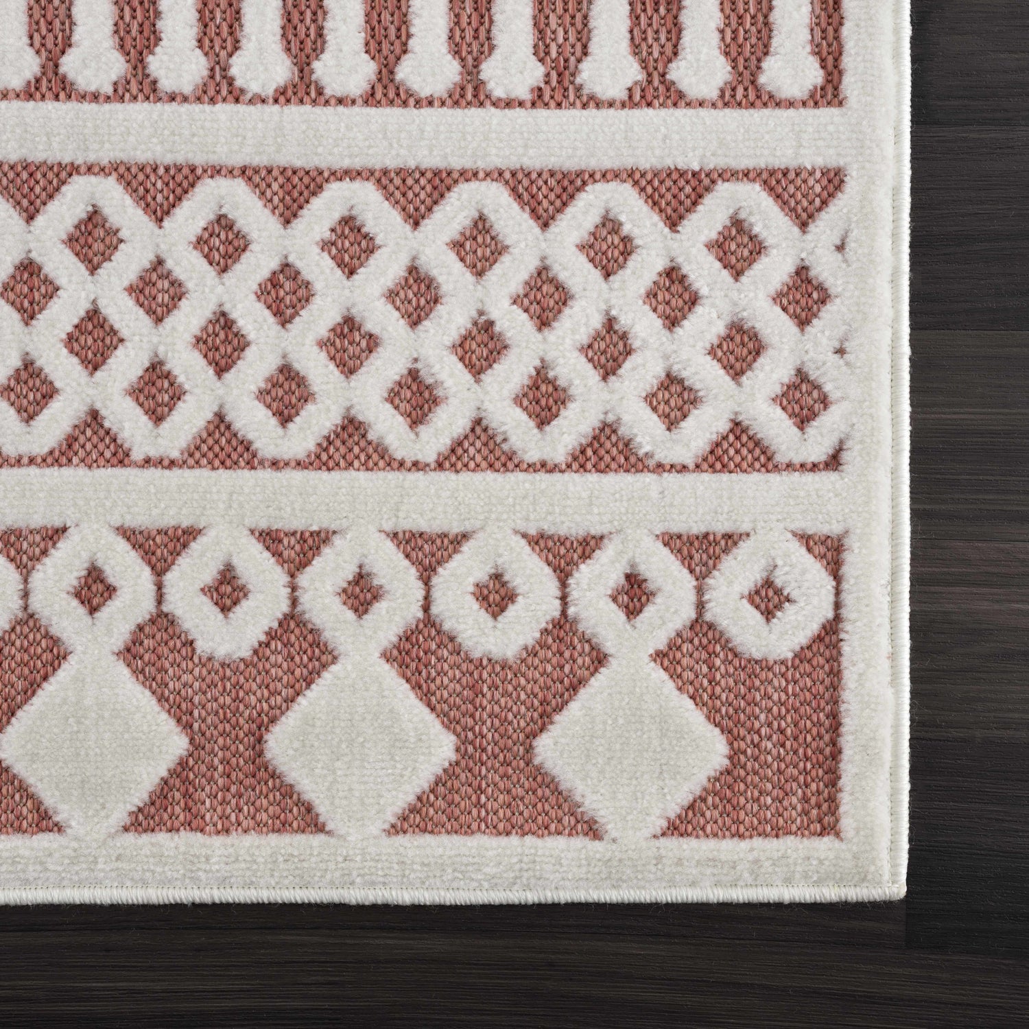 Close-up of the Jove Orange Outdoor Rug showing a bone and terracotta geometric Southwestern pattern. Swatch
