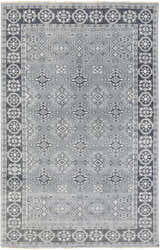 Close-up of the Sherwood Area Rug. Hand-knotted wool rug in ice blue, ink blue, and teal with a traditional geometric pattern. Design-Rectangle-5686