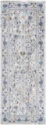 Close-up of the Irida Area Rug. Machine-woven rug in dark gray, denim, and light gray with a traditional floral pattern. Design-Runner-2773