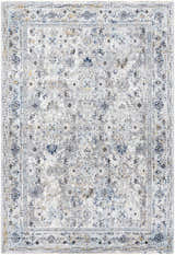 Close-up of the Irida Area Rug in dark gray, denim, and gray. Features a traditional floral pattern and machine-woven construction. Design-Rectangle-575