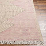 Close-up of the hand-woven Sang Area Rug. Features a geometric diamond pattern in dark pink, dusty pink, mauve, and tan. Front