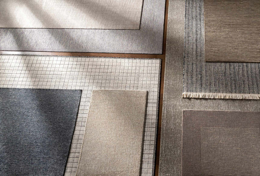 Close-up of various rug textures and colors, including the Lecompton Solid Charcoal Viscose Rug. Contemporary style. Styleshot