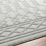 Close-up of the Kort SFG-2310 area rug. Bone, natural gray, and taupe geometric pattern with a textured, machine-woven design. Texture