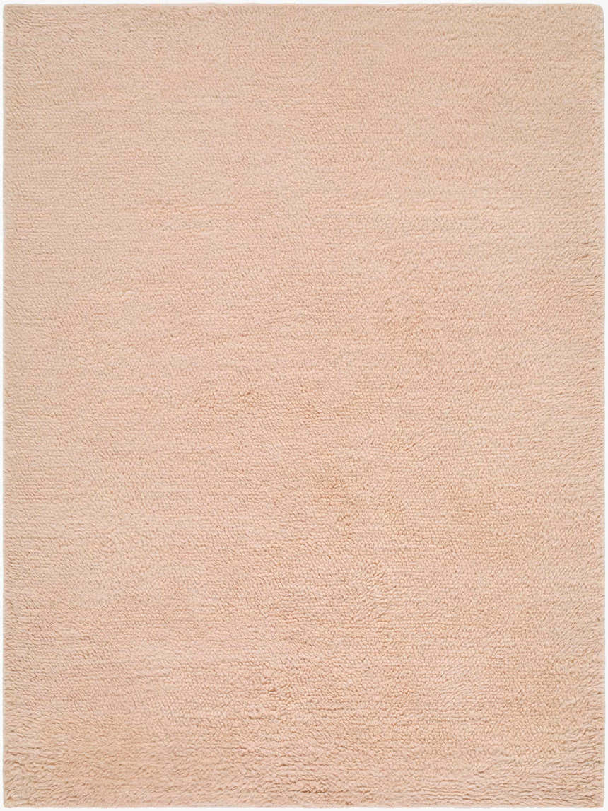 Close-up of the hand woven Kanuha Washable Area Rug. Plush, blush pink wool rug with a subtle texture. Design-Rectangle