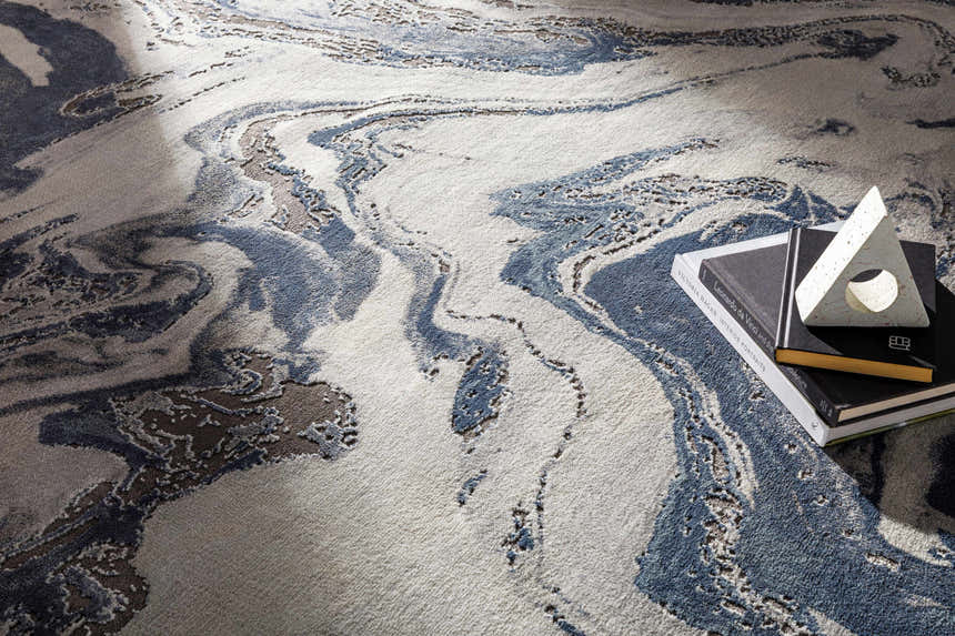 Close-up of the Moana Denim Blue Marble Area Rug showing the abstract pattern, denim blue, white, and charcoal colors. Styleshot