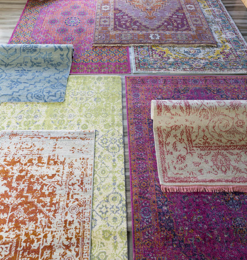 Variety of Boutique Rugs, including the Milliken Magenta Area Rug with burgundy, orange, gray, navy, and teal colors. Styleshot