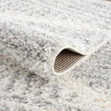 Close-up of the plush Trunding Area Rug in Gray, showing its soft texture and geometric pattern. Fold