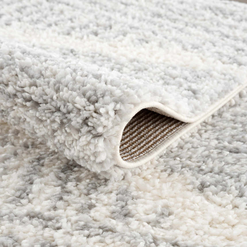 Close-up of the plush Trunding Area Rug in Gray, showing its soft texture and geometric pattern. Fold