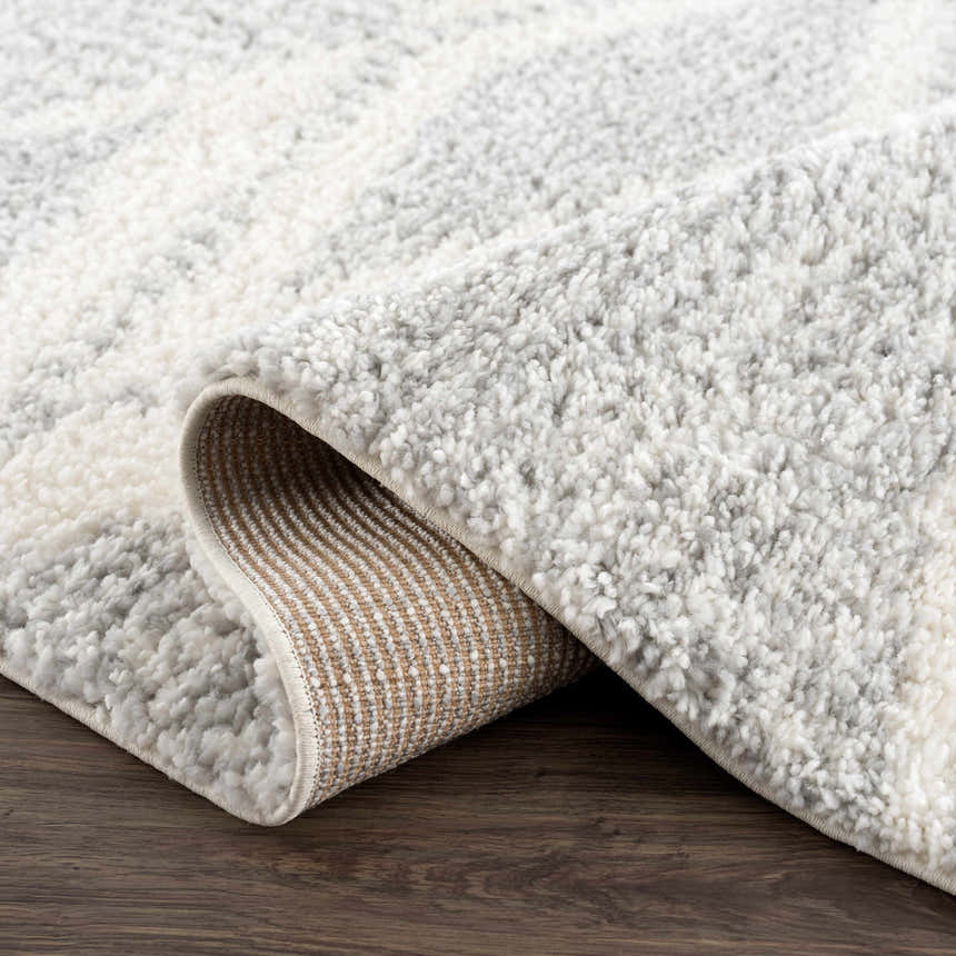 Close up of the Trunding Plush Area Rug in Gray, showing the shag texture and geometric pattern. Fold