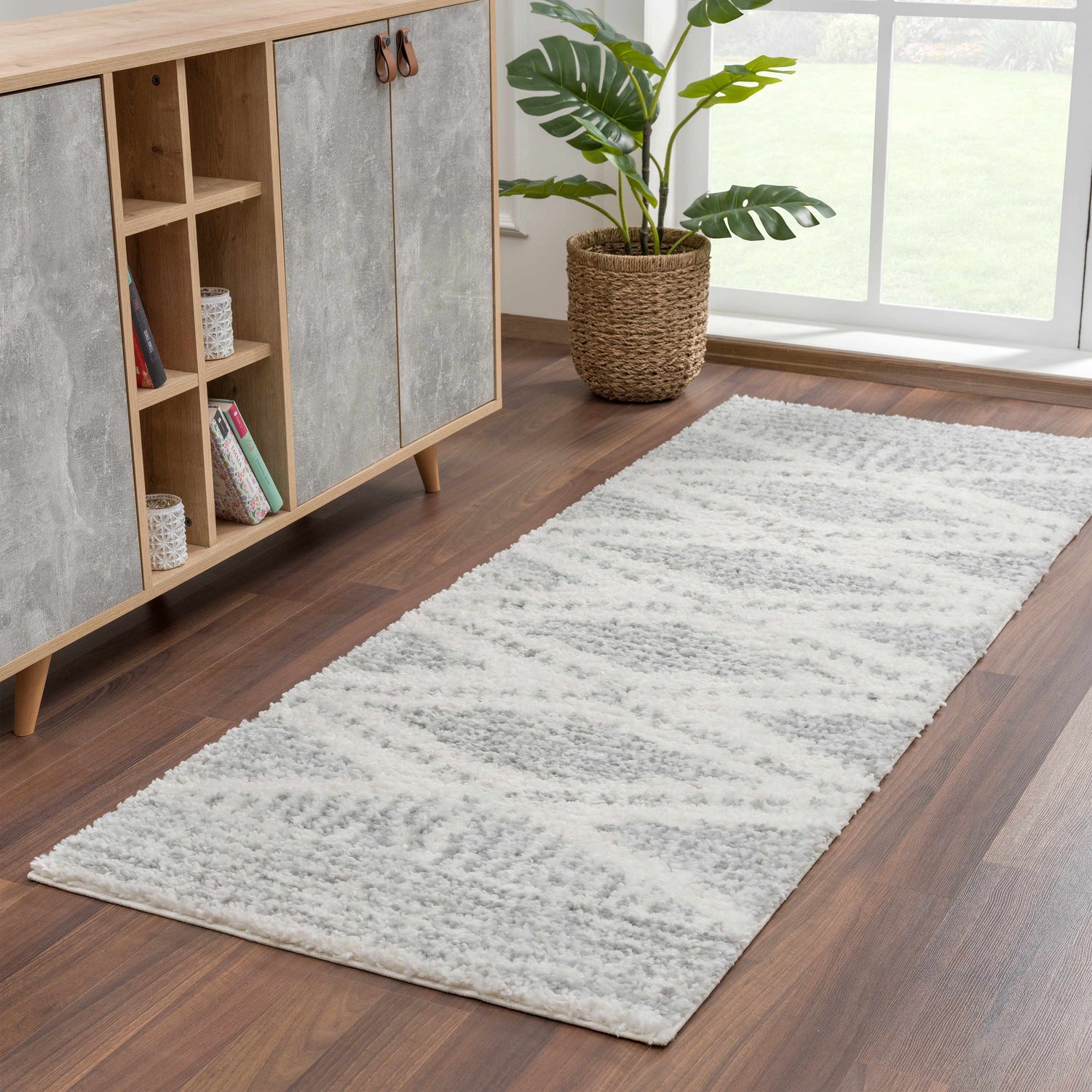 Hallway scene with gray Trunding Plush Area Rug, wood cabinet, and potted plant near a window. Roomscene-Runner