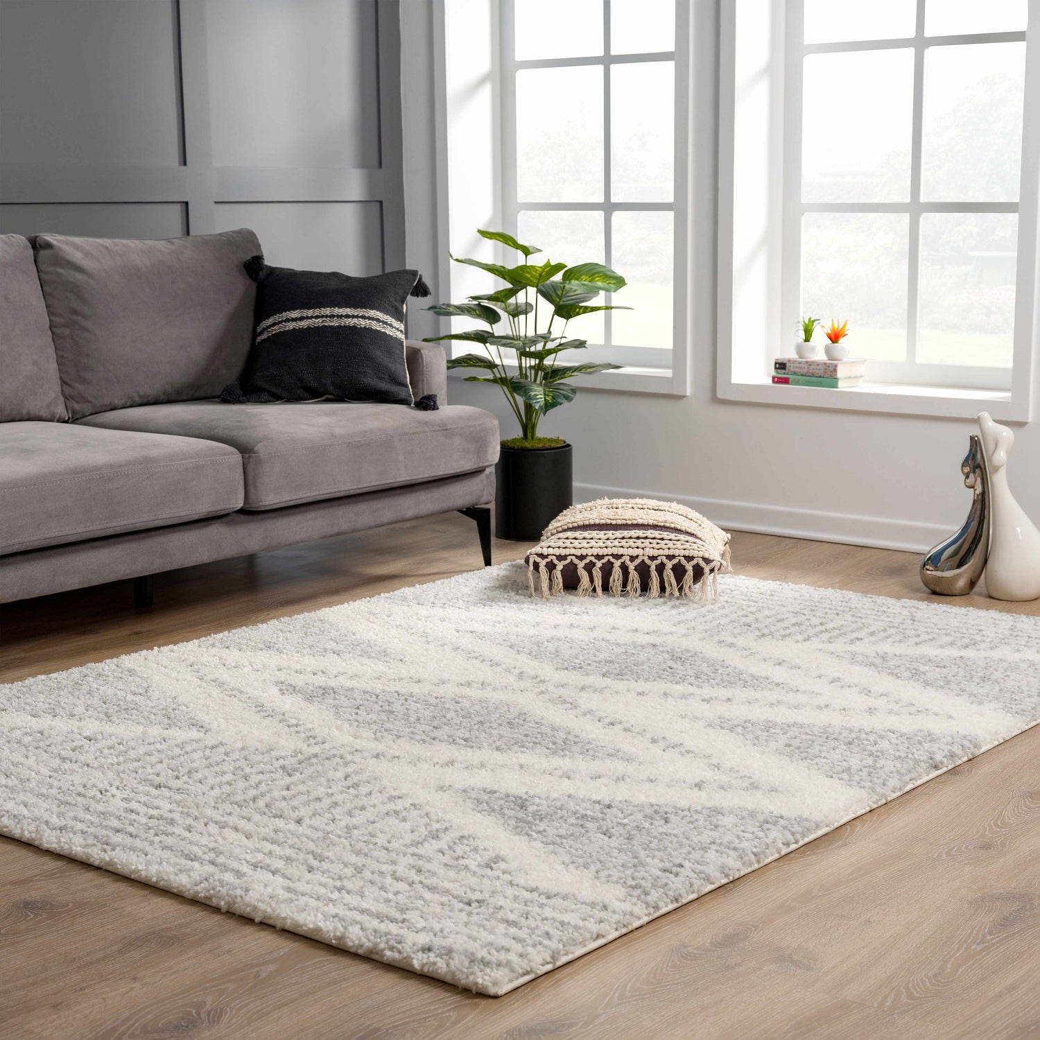 Living room scene with a gray sofa and the Trunding Plush Area Rug in Gray with a geometric pattern. Roomscene-Rectangle