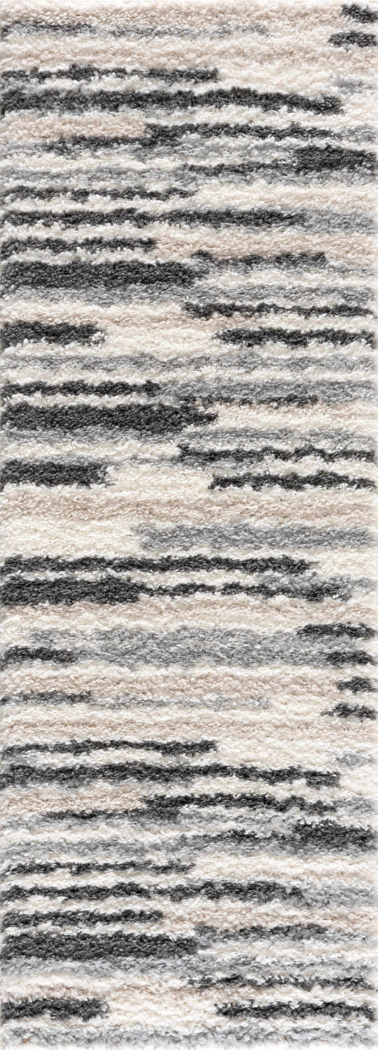 Close-up of Zoya Irregular Striped Area Rug. Shag rug with beige, cream, and gray irregular horizontal stripes. Soft texture. Design-Runner-2773