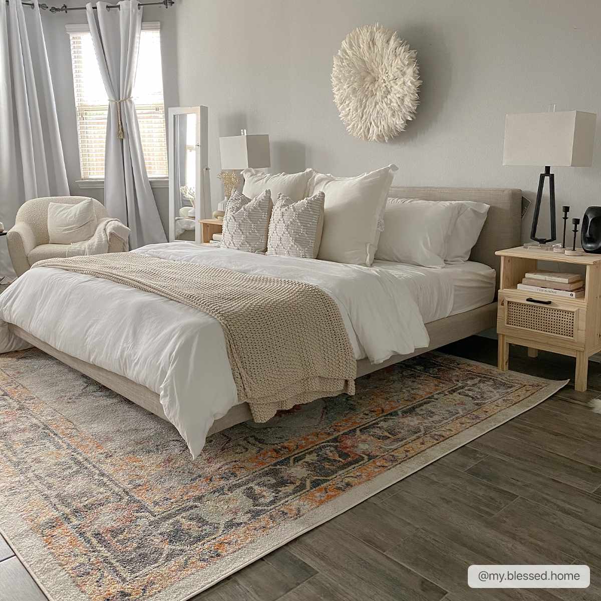 Serene bedroom with a beige bed and the orange and gray Hillcrest Area Rug adding warmth to the gray wood floors. Roomscene-Rectangle