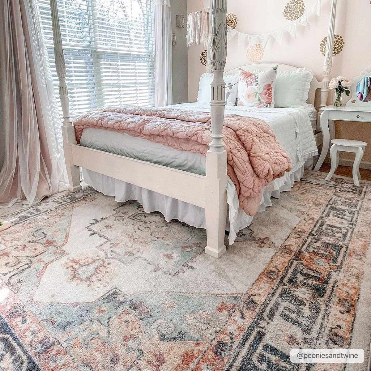 Light and airy bedroom scene with a white four-poster bed and the beige, blue, and rust Hillcrest Area Rug. Roomscene-Rectangle