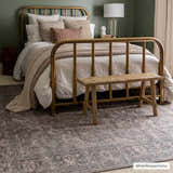 Bedroom scene with gold bed frame and Greenpoint Dusty Blue Washable Rug. Vintage style with beige and blue tones. Roomscene-Rectangle
