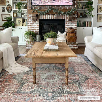 Farmhouse living room with brick fireplace and Rosman Distressed Washable Area Rug in beige, blue, and brick red. Roomscene-Rectangle