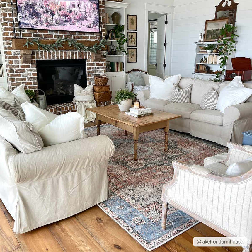 Farmhouse living room with beige sofas and a Rosman Distressed Washable Area Rug in beige, red, and blue tones. Roomscene-Rectangle