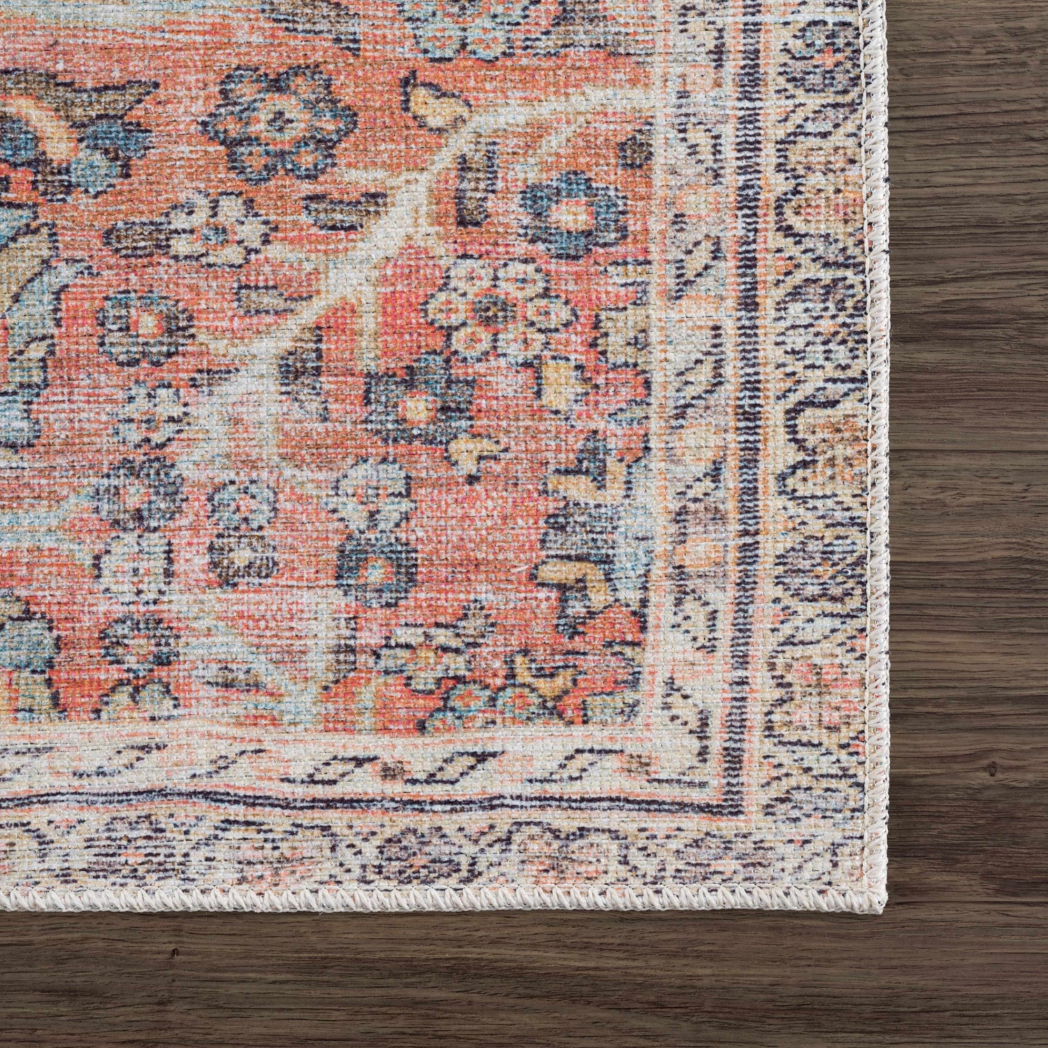 Close-up of the Urpi Rose & Blue Washable Area Rug showing its traditional Persian-style pattern and colors. Swatch