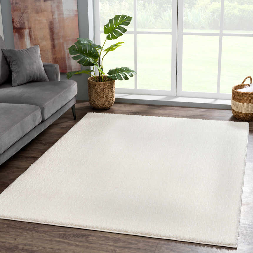 Living room scene with gray sofa and Judy White Washable Area Rug on dark wood floor, creating a bright, modern farmhouse feel. Roomscene-Rectangle