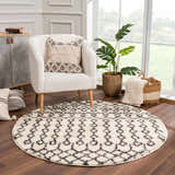 Cozy living room scene with round Muni Berber Shag Rug, white armchair, and natural light. Bohemian, farmhouse style. Roomscene-Round