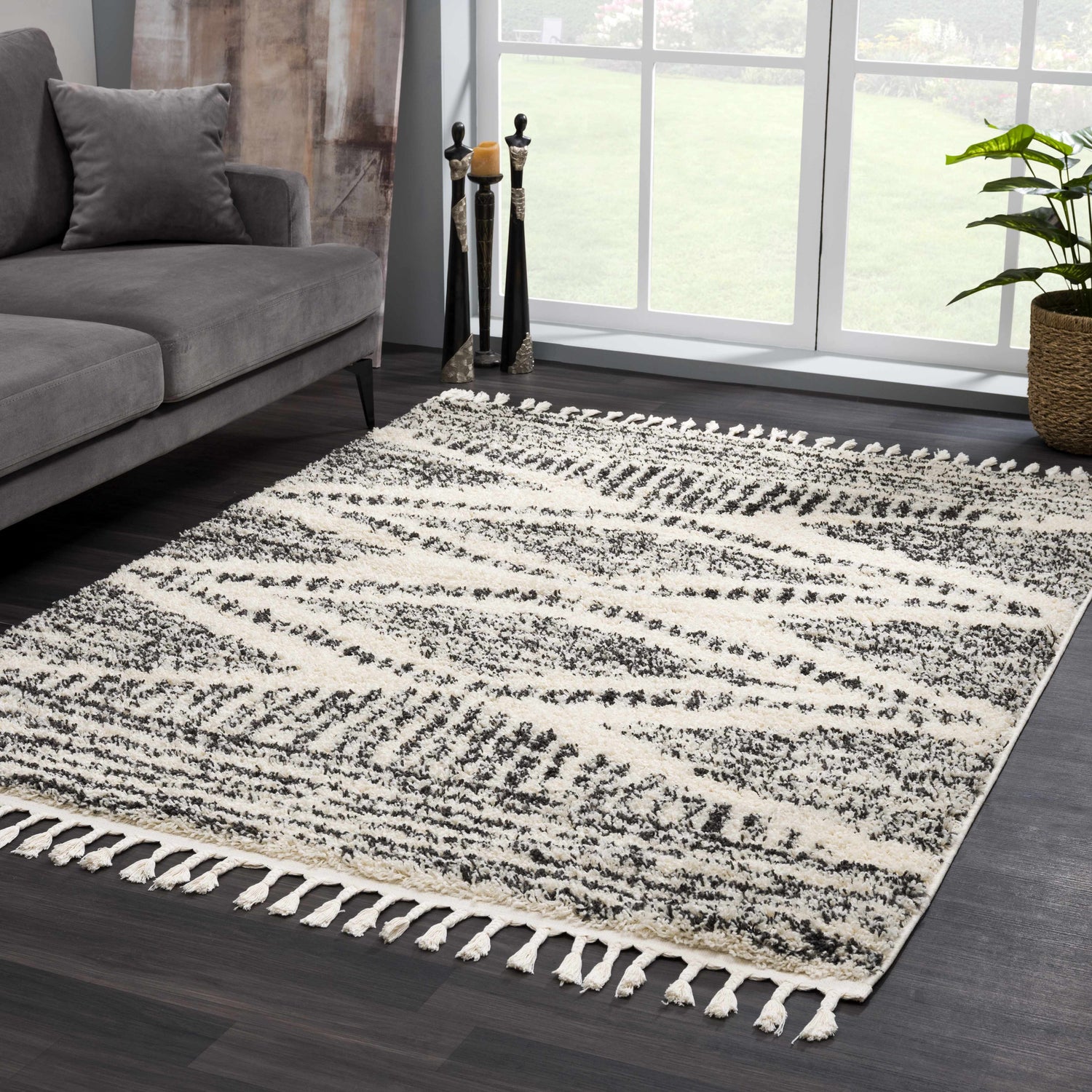 Living room scene with gray sofa and Fishhook Berber Shag Rug in dark gray, lambswool, and nutmeg colors. Roomscene-Rectangle
