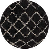 Close-up of a round Wallagrass Black Moroccan Shag Rug. Charcoal rug with light beige geometric diamond pattern. Shag texture. Design-Round
