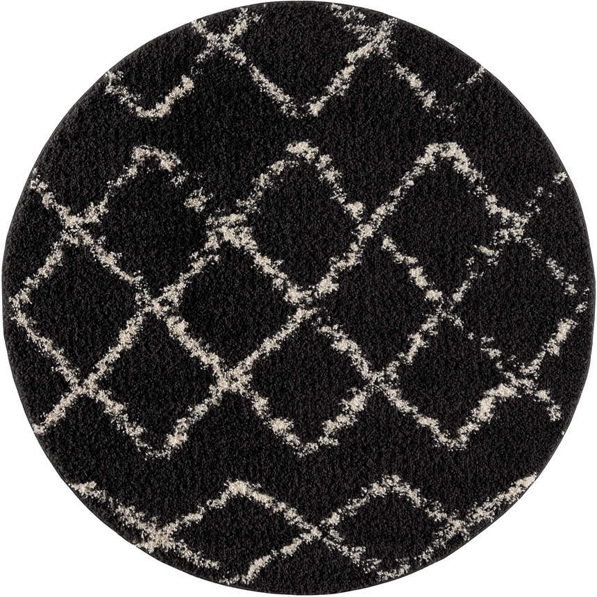 Close-up of a round Wallagrass Black Moroccan Shag Rug. Charcoal rug with light beige geometric diamond pattern. Shag texture. Design-Round