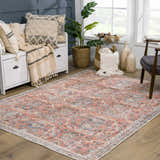 Living room scene with Urpi Rose & Blue Washable Area Rug. Farmhouse style with peach, blue, and cream tones. Roomscene-Rectangle