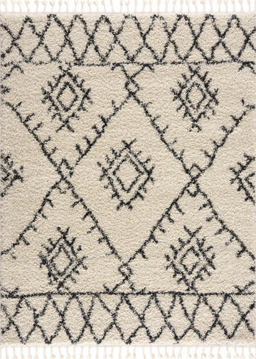 Close-up of Emlenton Berber Shag rug. Charcoal tribal pattern on light beige shag with tassels. Bohemian style. Design-Rectangle