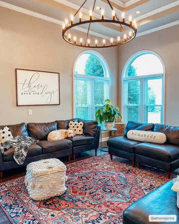 Living room with leather sofas and the red and blue Neyland Area Rug. A dog sleeps on the couch. Roomscene-Rectangle
