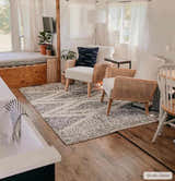Living room scene with a charcoal and cream Trunding Plush Area Rug, rattan chairs, and wood accents. Roomscene-Rectangle