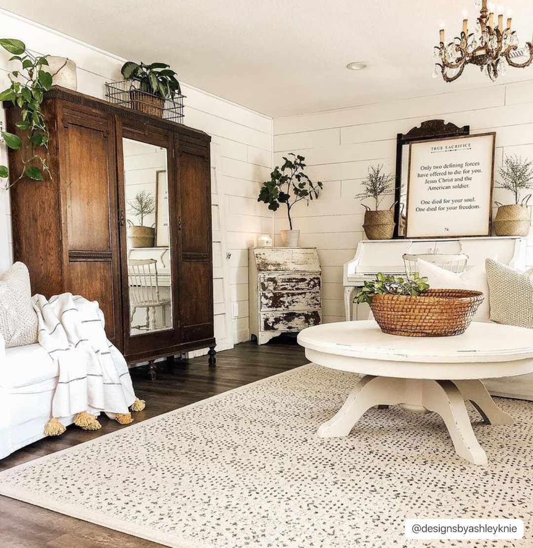 Farmhouse living room with a beige Sattley Area Rug, white furniture, and wood accents. Roomscene-Rectangle